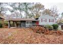 Charming split level home with red door, painted brick and a covered side entrance at 2475 Harvel Nw Dr, Atlanta, GA 30318