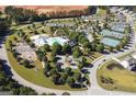 Aerial view showcasing the community amenities: pool, tennis courts, basketball court, playground, walking trails, and community garden at 81 Richmond Way, Villa Rica, GA 30180