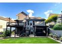 Expansive backyard featuring a spacious deck, covered patio, and lush green lawn perfect for outdoor entertaining at 81 Richmond Way, Villa Rica, GA 30180