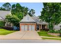 Beautiful brick-and-siding home with well-manicured landscaping, and a two-car garage at 81 Richmond Way, Villa Rica, GA 30180