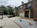 Lovely townhome with attached garage, landscaped yard, and inviting entrance at 1649 Southgate Mill Nw Dr, Duluth, GA 30096