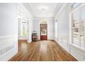 Inviting foyer with hardwood floors, wainscoting, large window, and wood door at 1121 Vinings Grove Se Way, Smyrna, GA 30082