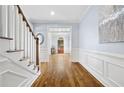 Elegant foyer with hardwood floors, staircase, wainscoting, and an arched entryway at 1121 Vinings Grove Se Way, Smyrna, GA 30082