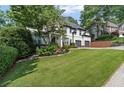 Beautiful two-story home showcasing lush landscaping, a well-maintained lawn, and a two-car garage at 3803 Upland Dr, Marietta, GA 30066