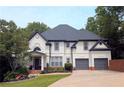 Inviting two-story home featuring a manicured lawn, tasteful landscaping, and a convenient two-car garage at 3803 Upland Dr, Marietta, GA 30066