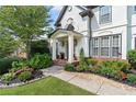 Beautiful front yard features lush landscaping leading up to the stately entrance of the home at 3803 Upland Dr, Marietta, GA 30066