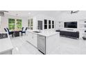 Bright, open-concept kitchen and living room with a large island and stainless steel appliances at 5264 Prestley Crossing Ln, Douglasville, GA 30135