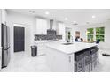 Modern kitchen features white cabinetry, island with seating, and stainless steel appliances at 5264 Prestley Crossing Ln, Douglasville, GA 30135