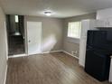 Kitchen features laminate flooring, stainless steel sink, and adjacent staircase at 8415 Magnolia Dr, Jonesboro, GA 30238