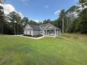 Attractive single-Gathering home featuring a well-maintained lawn and a covered front porch, surrounded by mature trees at 190 Paul Aiken Rd, Dallas, GA 30157