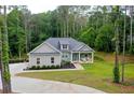 Inviting single-story home with a well-manicured lawn and a covered porch for relaxation at 190 Paul Aiken Rd, Dallas, GA 30157