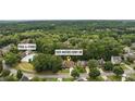 Community view featuring a home close to the pool and tennis courts, nestled in a wooded neighborhood at 1925 Waters Ferry Dr, Lawrenceville, GA 30043