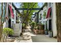 Charming courtyard featuring mature trees, lush landscaping, and access to multiple townhome-style residences at 195 Arizona Ne Ave # 197, Atlanta, GA 30307