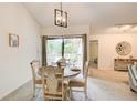 Cozy dining area with stylish light fixture and sliding glass door to a deck at 202 Garden Ct, Atlanta, GA 30328