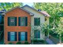 Charming two-story home with brick and siding exterior, complemented by lush landscaping at 202 Garden Ct, Atlanta, GA 30328