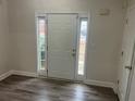 Bright foyer with new grey floors and sidelight windows flanking the front door at 2682 Field Spring Dr, Lithonia, GA 30058