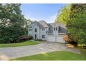 Charming two-story home with manicured lawn and a long driveway at 3525 Stone Cliff Way, Woodstock, GA 30189