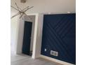 Contemporary living room with an navy accent wall and modern lighting fixture at 6716 Browns Mill Rd, Lithonia, GA 30038