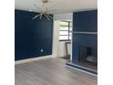 Living room with a navy accent wall and a fireplace at 6716 Browns Mill Rd, Lithonia, GA 30038