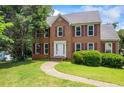 Attractive two-story brick home with a manicured lawn and classic design at 2196 Kildare Nw Way, Kennesaw, GA 30152