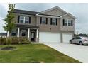 Two-story home with a brick facade, black shutters, and a well-maintained lawn with landscaped shrubs at 3378 English Elm Way, Loganville, GA 30052