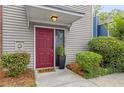 Inviting townhome exterior with a vibrant red door and manicured greenery at 812 Dixie Ne Ave, Atlanta, GA 30307