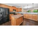 Spacious kitchen with wood cabinets, black appliances, and center island perfect for entertaining at 262 Bell Grove Ln, Suwanee, GA 30024