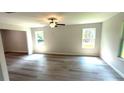 Bright living room featuring laminate floors and natural light from the windows at 45 Emerald Ln, Covington, GA 30014