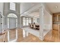 Inviting foyer featuring hardwood floors, grand pillars, and an open layout leading to the dining area at 5357 Harbury Cv, Suwanee, GA 30024