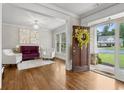 Bright foyer with hardwood floors, elegant seating, and a view to the outside at 10 Nesbit Reserve Ct, Atlanta, GA 30350