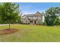 Charming two-story home with a well-maintained lawn and stone-accented facade at 10 Nesbit Reserve Ct, Atlanta, GA 30350