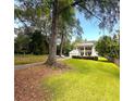 Landscaped lawn showing a charming two-story home with a detached garage and a long driveway at 1242 Star Ne Dr, Brookhaven, GA 30319