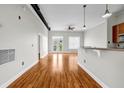 Open living room and kitchen area with hardwood floors, white walls, and modern finishes at 502 Sw Pryor Sw St # 325, Atlanta, GA 30312