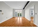 Spacious living room featuring hardwood floors, white walls, and a balcony overlooking trees at 502 Sw Pryor Sw St # 325, Atlanta, GA 30312