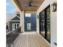 Inviting balcony with wood floors, wood ceiling and black metal railings offering outdoor living space at 555 Orme Ne Cir, Atlanta, GA 30306