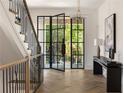 Elegant foyer with hardwood floors, a glass door, console table and staircase at 555 Orme Ne Cir, Atlanta, GA 30306