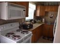 Well-lit kitchen featuring wooden cabinets and modern appliances at 3400 Scott Dr, Austell, GA 30106