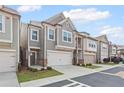 Inviting two-story townhome with attached garage and meticulously maintained landscaping at 323 Hayden Circle Cir, Woodstock, GA 30189
