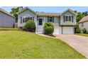 Charming split-level home features a well-manicured lawn, a two-car garage, and inviting curb appeal at 4255 Brandy Ann Dr, Acworth, GA 30101