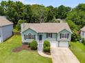 Charming split-level home featuring a manicured lawn, a two-car garage, and inviting curb appeal at 4255 Brandy Ann Dr, Acworth, GA 30101