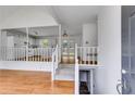 Inviting foyer with hardwood floors, leading to an open-concept kitchen with white cabinets and a breakfast bar at 4255 Brandy Ann Dr, Acworth, GA 30101