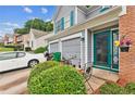 Welcoming front entrance with a teal door, and a two-car garage, enhancing curb appeal at 4945 Penscot Way, Stone Mountain, GA 30088