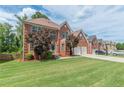 Two-story brick home with a well-manicured lawn and trees providing shade and curb appeal at 118 Surge Stone Ln, Stockbridge, GA 30281