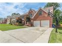 Two-story brick home featuring a basketball hoop and an extended driveway at 118 Surge Stone Ln, Stockbridge, GA 30281