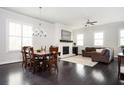 Open-concept living area with a dining table and chairs near the living room fireplace at 2026 Forte Lane, Alpharetta, GA 30009