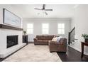 Cozy living room with fireplace, neutral paint, and hardwood floors at 2026 Forte Lane, Alpharetta, GA 30009