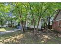 Cozy single-story home with mature trees enhancing the curb appeal at 2988 E Point Pt, East Point, GA 30344