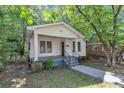 Inviting single-story home with a covered front porch and iron window bars at 2988 E Point Pt, East Point, GA 30344