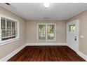 Bright living room featuring hardwood floors, a large window, and neutral paint at 2988 E Point Pt, East Point, GA 30344