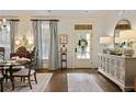 Elegant dining room with hardwood floors, decorative mirror, and ample natural light, perfect for entertaining guests at 515 Saint Barbaras Nw Ln, Marietta, GA 30064